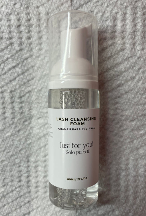 Lash cleansing foam bottle labeled 'Just for you!' on a textured gray background